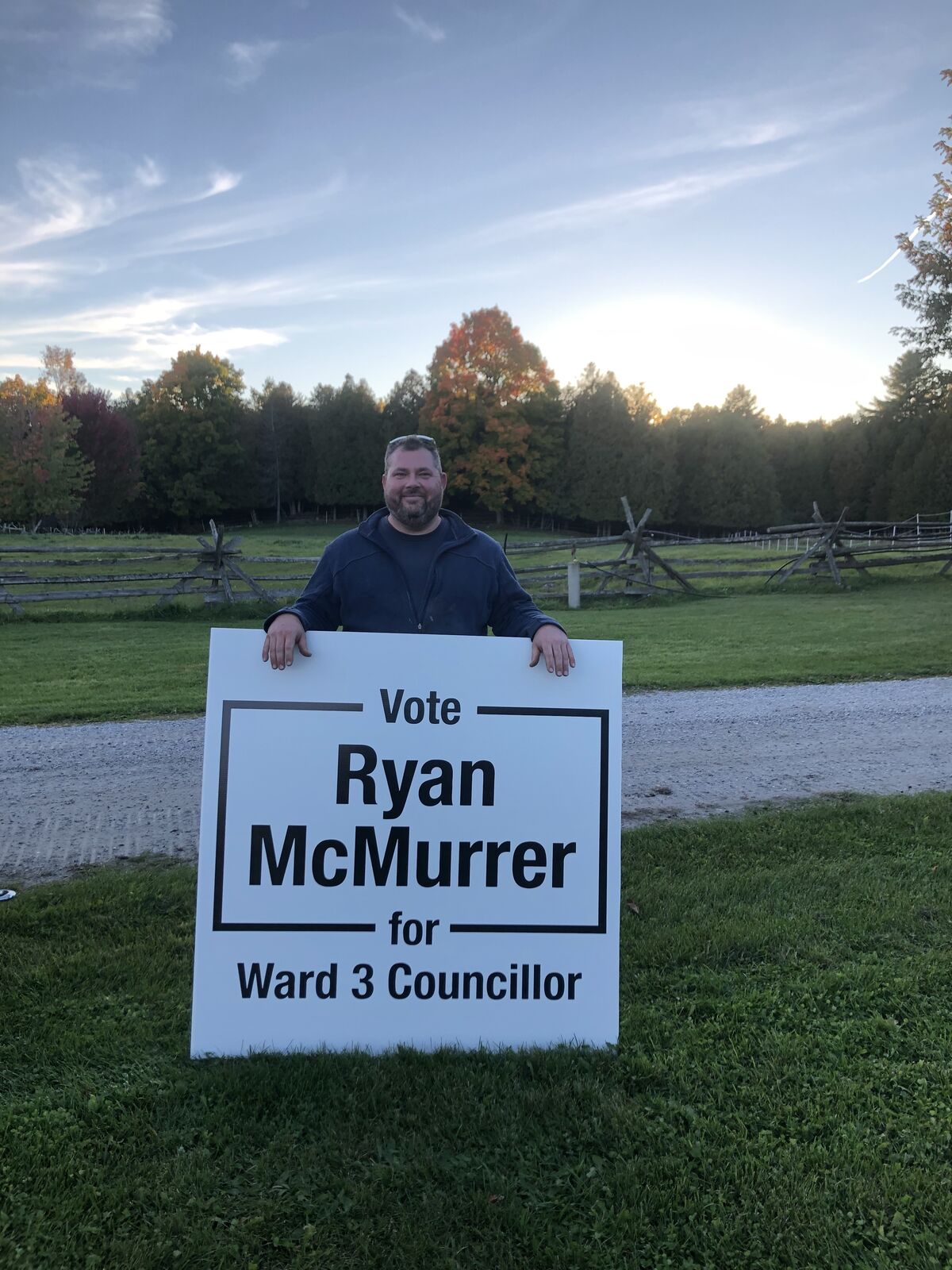 Ryan standing in the winter woods beside a UTV, working the land in Ward 3.