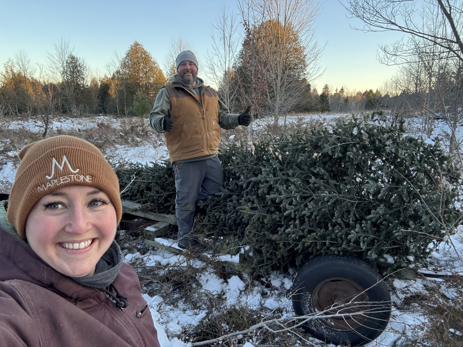 Ryan and Tausha at their tree farm in winter, loading a trailer.